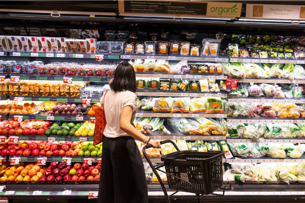 Girl in grocery store looking at fruits
